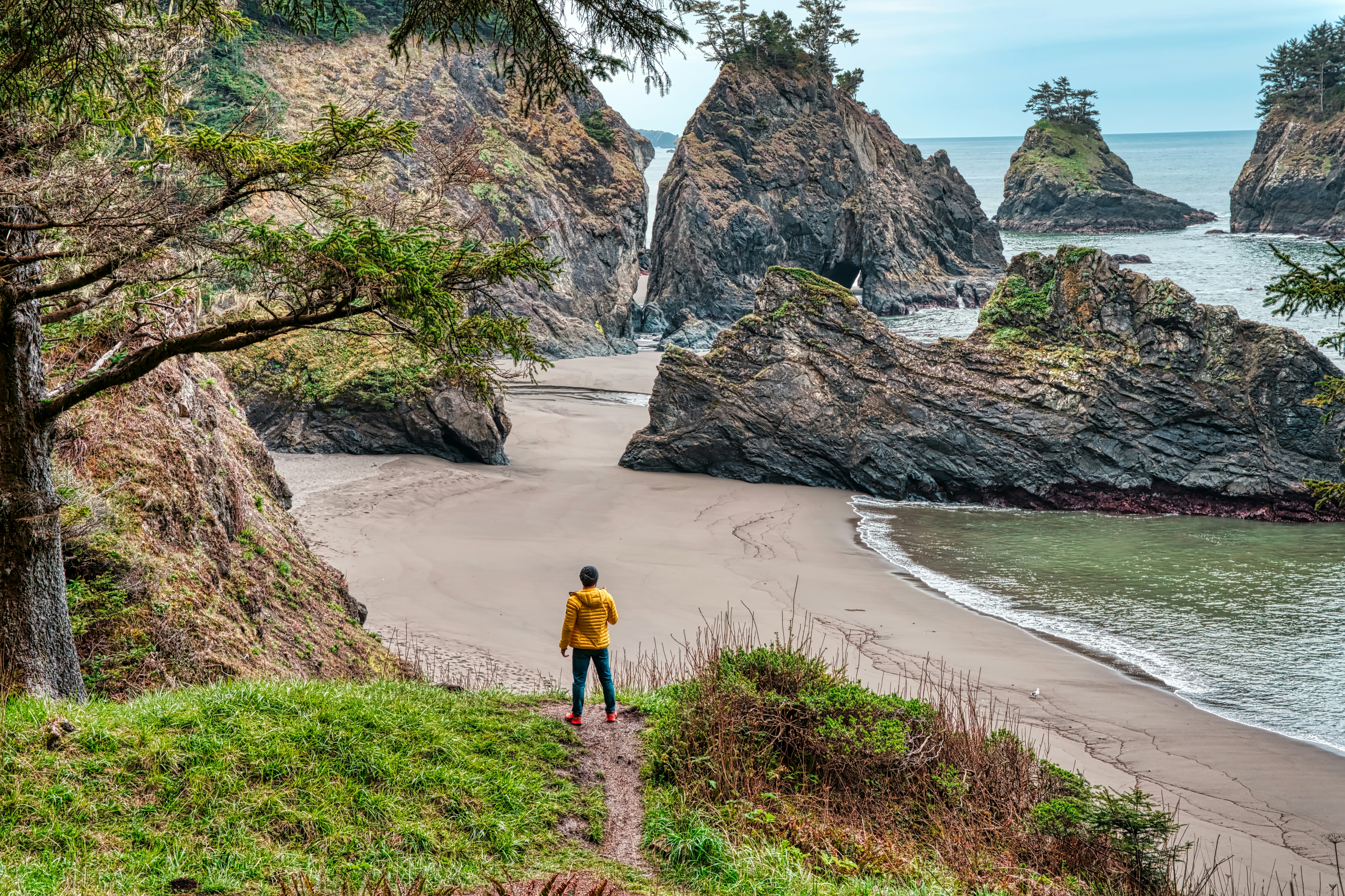 woman in yellow shirt walking on beach during daytime